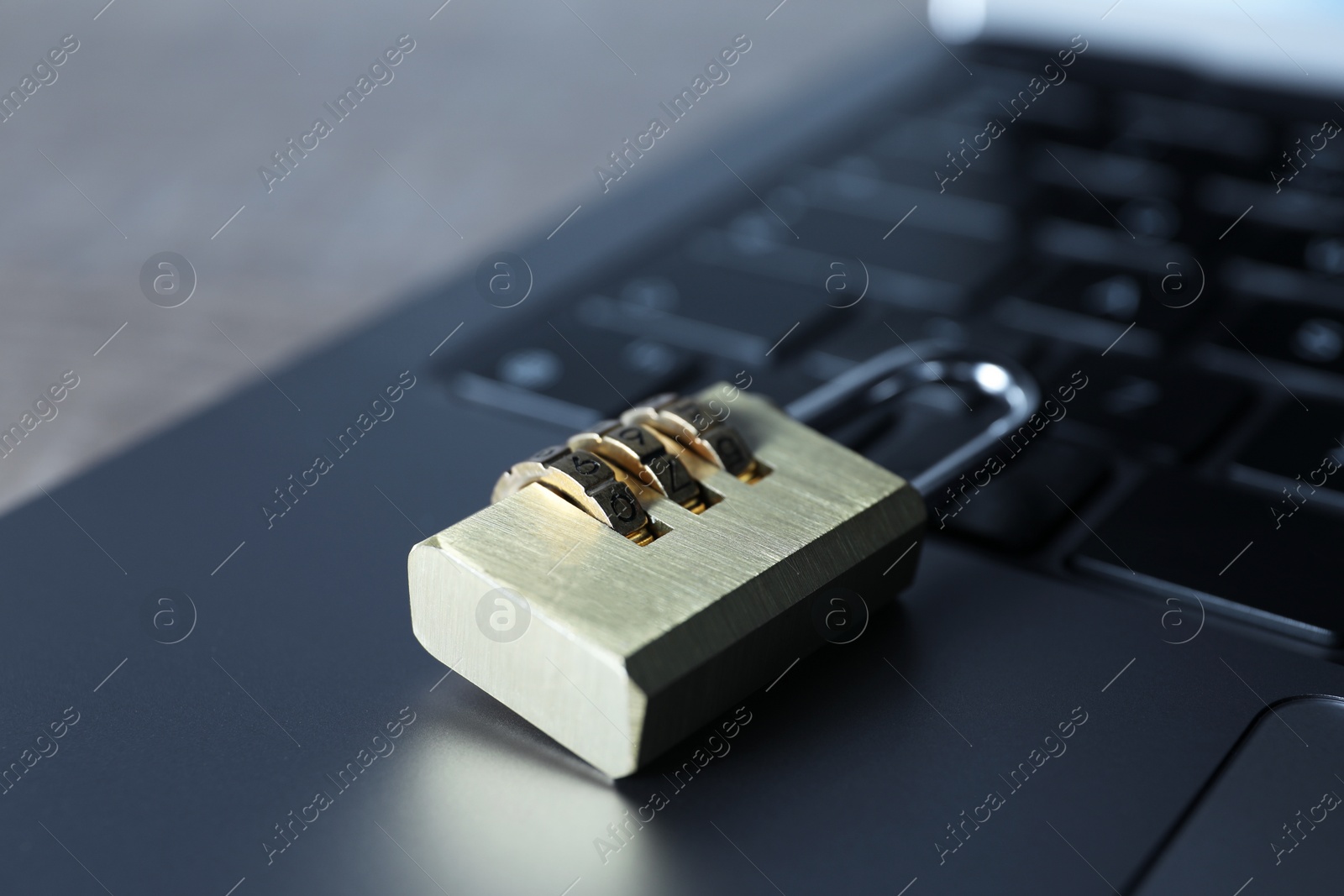 Photo of Cyber security. Laptop with padlock on table, closeup