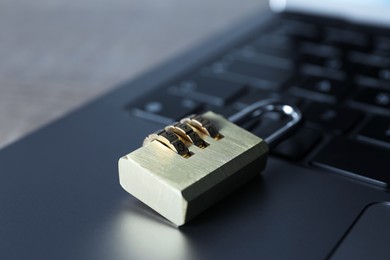 Photo of Cyber security. Laptop with padlock on table, closeup