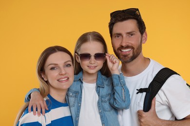 Portrait of happy family on orange background