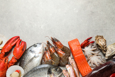 Photo of Fresh fish and seafood on marble table, flat lay. Space for text