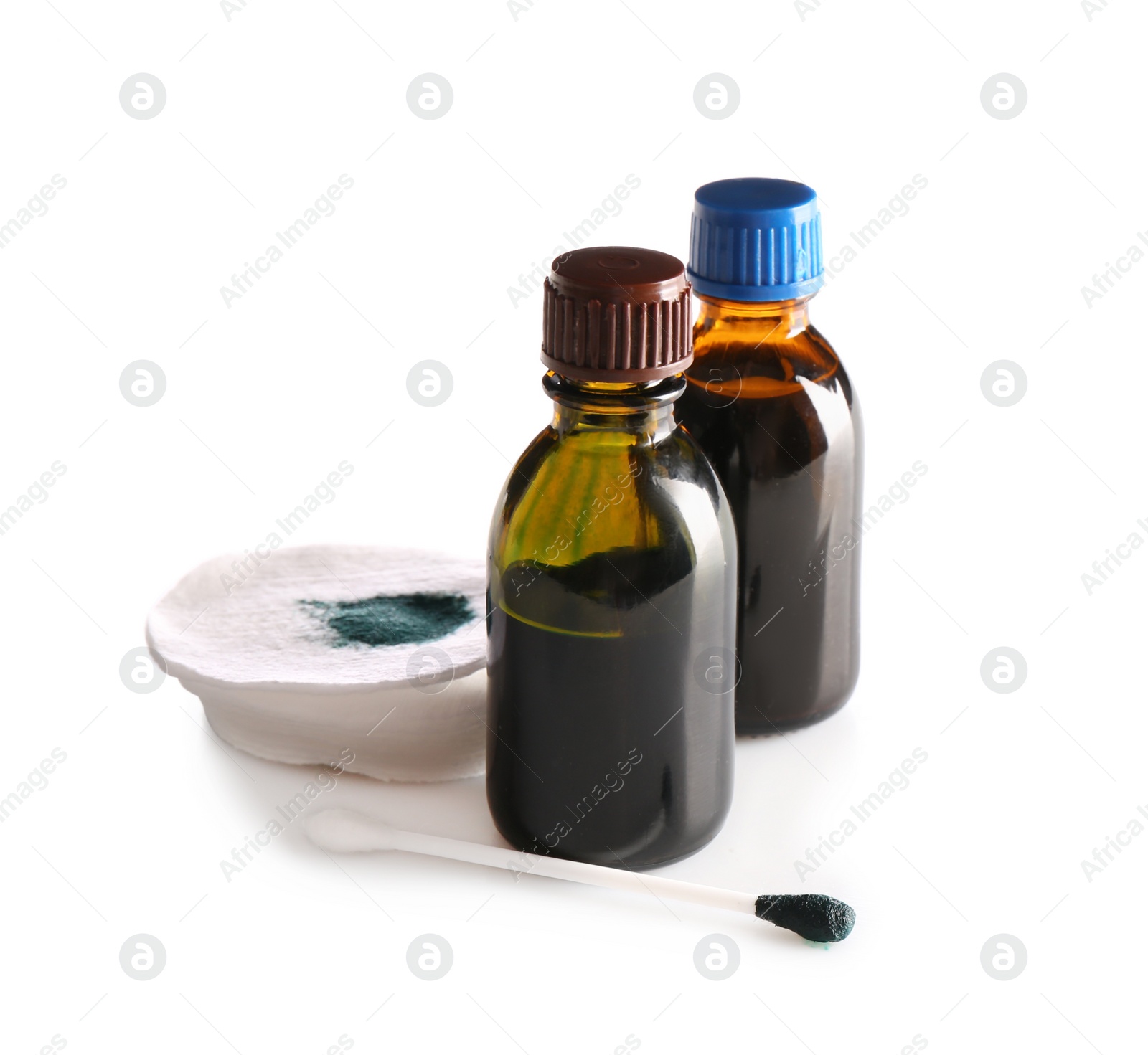 Photo of Bottles of brilliant green, cotton bud and pads on white background