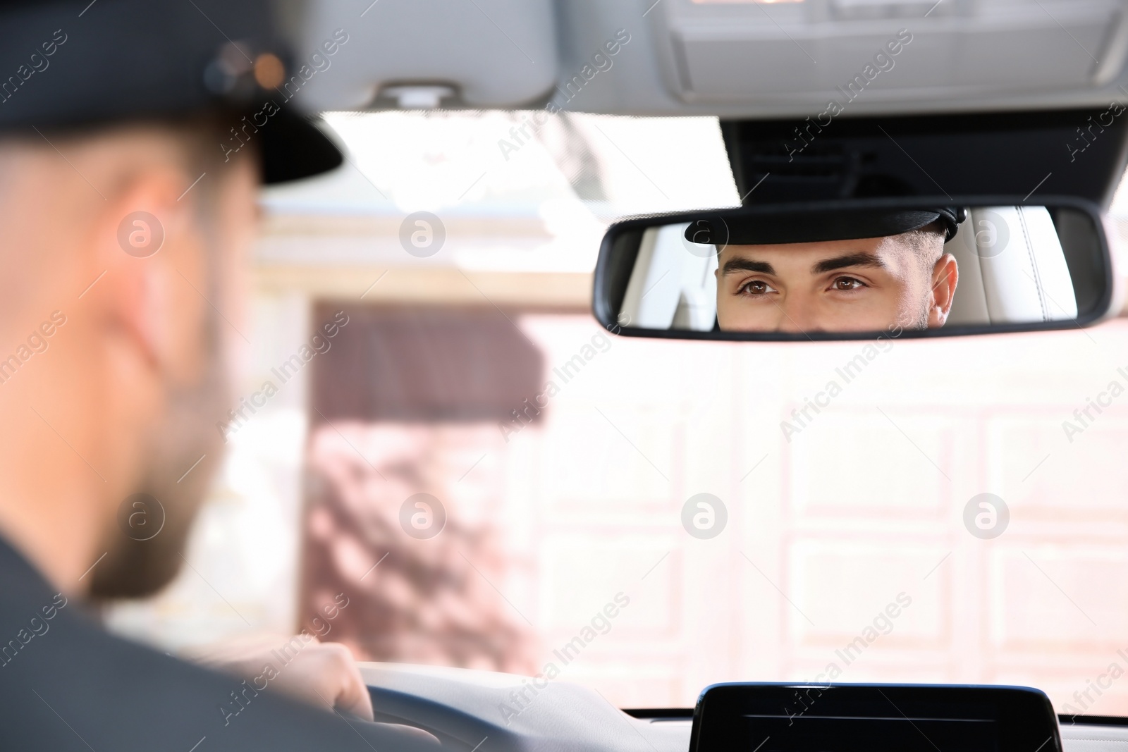 Photo of Young driver in luxury car. Chauffeur service