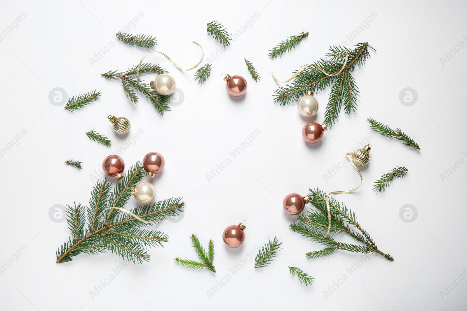 Photo of Frame of Christmas tree branches and festive decoration on white background, top view. Space for text