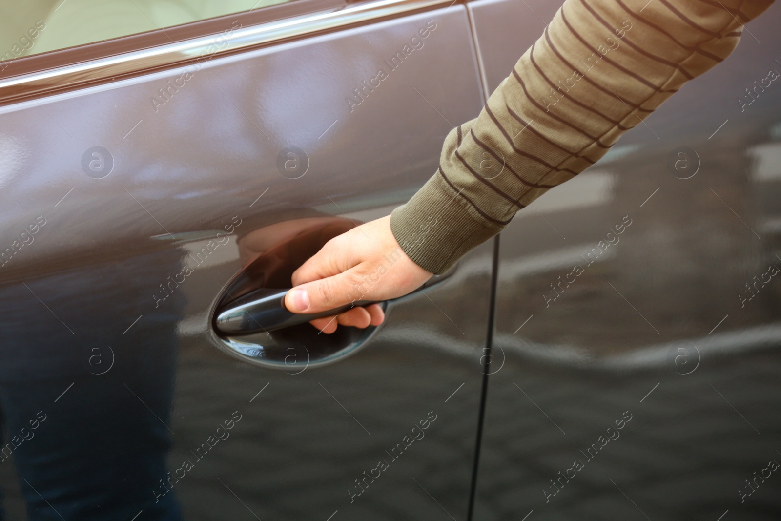 Photo of Closeup view of man opening car door