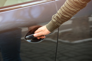 Closeup view of man opening car door