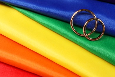 Photo of Wedding rings on rainbow LGBT flag, closeup