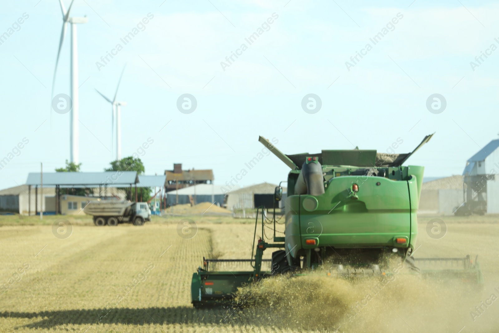 Photo of Modern combine harvester working in agricultural field