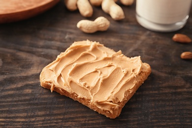 Photo of Tasty toast with peanut butter on table