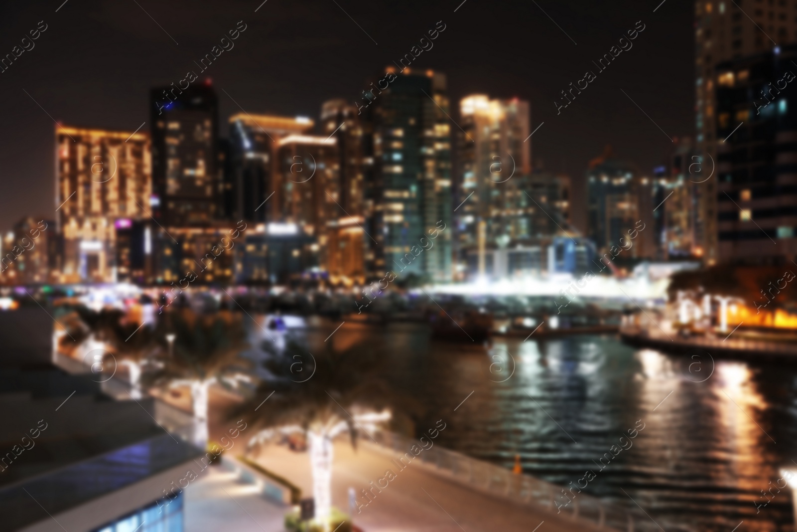 Photo of DUBAI, UNITED ARAB EMIRATES - NOVEMBER 03, 2018: Night cityscape of marina district with illuminated buildings, blurred view