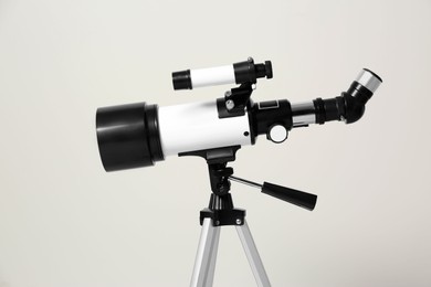 Tripod with modern telescope on white background, closeup