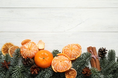 Flat lay Christmas composition with fresh tangerines on white wooden table. Space for text
