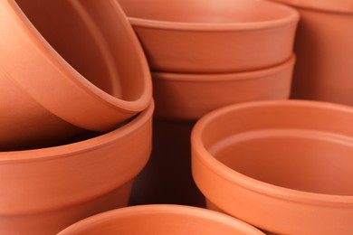 Photo of Many clay flower pots as background, closeup