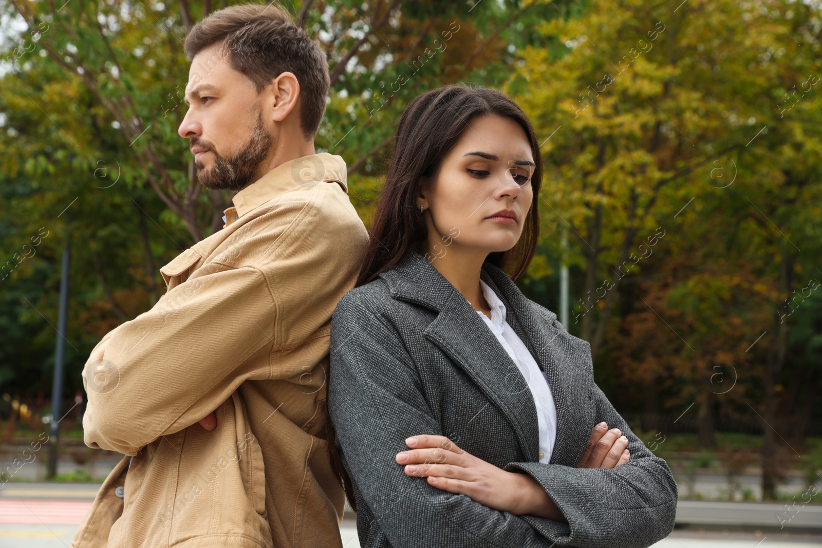 Photo of Upset arguing couple in park. Relationship problems