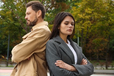 Upset arguing couple in park. Relationship problems