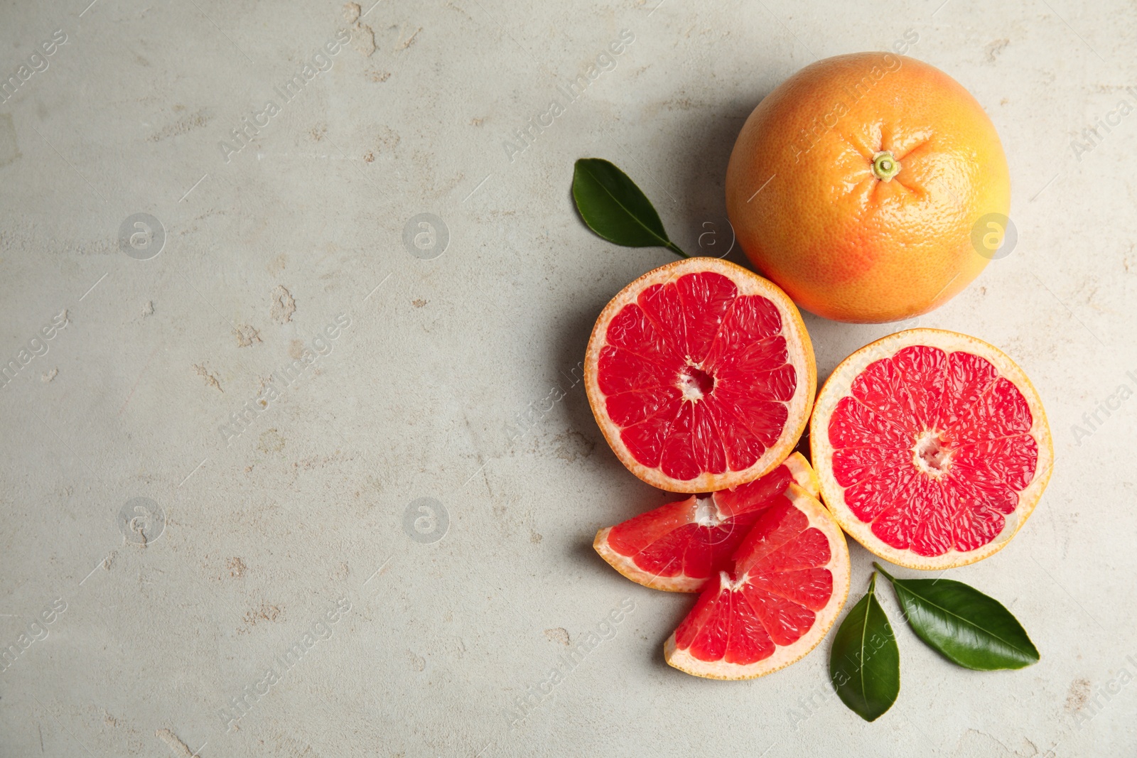 Photo of Fresh tasty grapefruits on table, top view with space for text