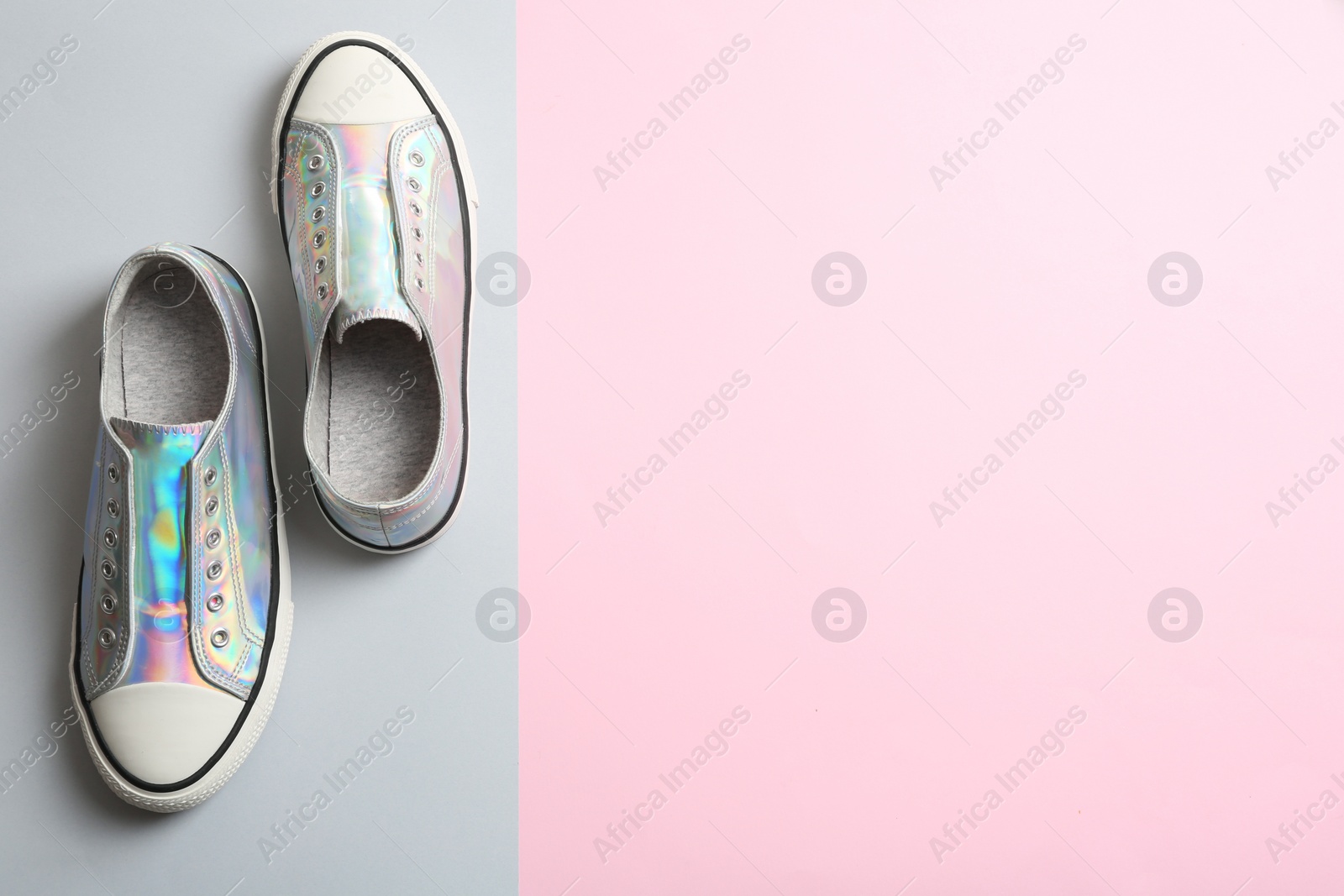 Photo of Stylish sneakers on color background, top view with space for text