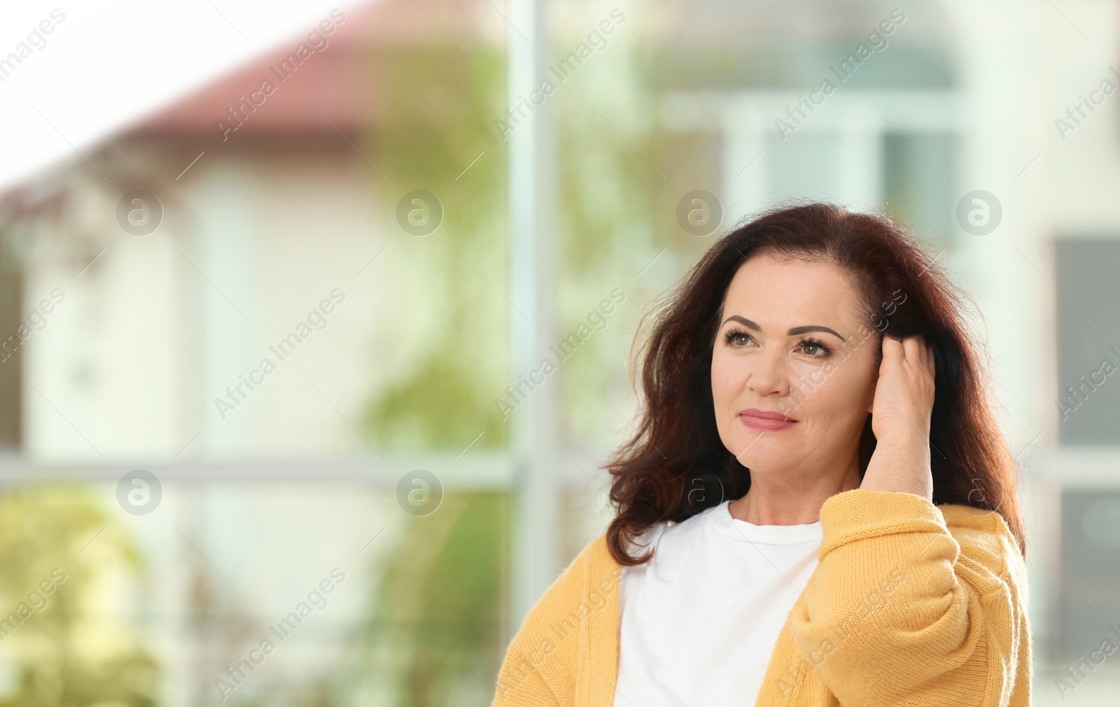 Photo of Portrait of beautiful older woman against blurred background with space for text