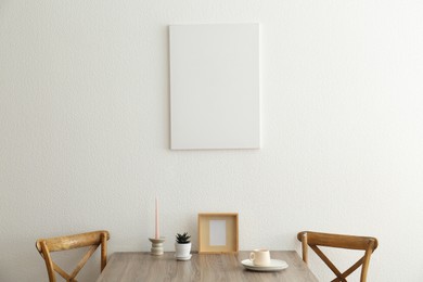 Room interior with dining table, wooden chairs and poster