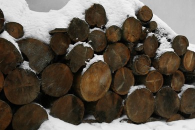 Photo of Stacked wood in winter outdoors, closeup view