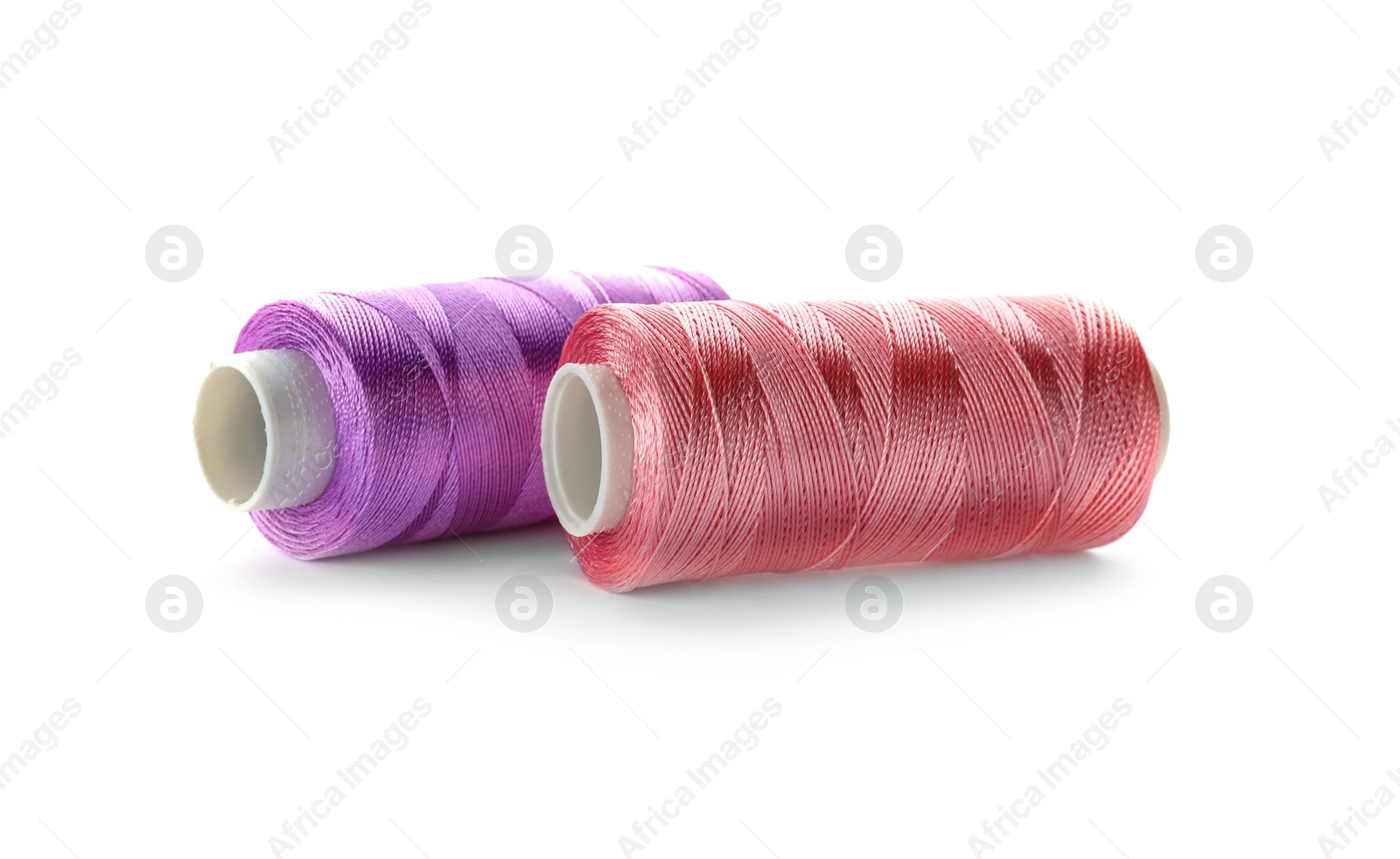 Photo of Color sewing threads on white background