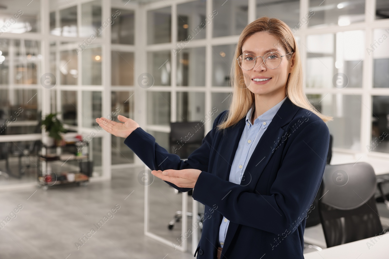 Photo of Happy female real estate agent in office