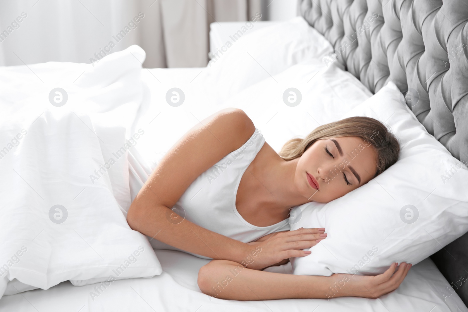 Photo of Beautiful teen girl sleeping with comfortable pillow in bed at home