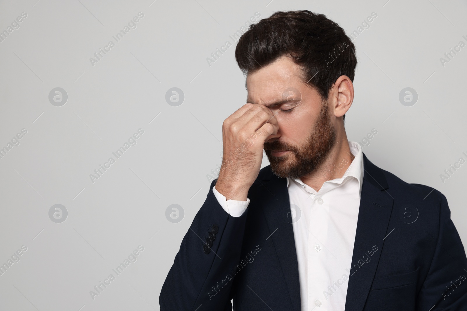 Photo of Man suffering from eyestrain on light grey background. Space for text