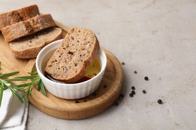 Bowl of organic balsamic vinegar with oil served with spices and bread slices on beige table. Space for text
