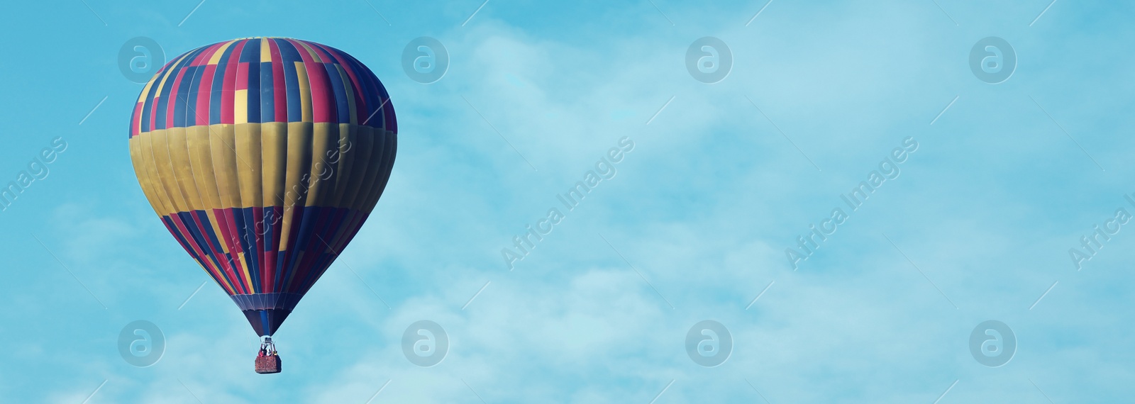 Image of Hot air balloon in blue sky, space for text. Banner design 