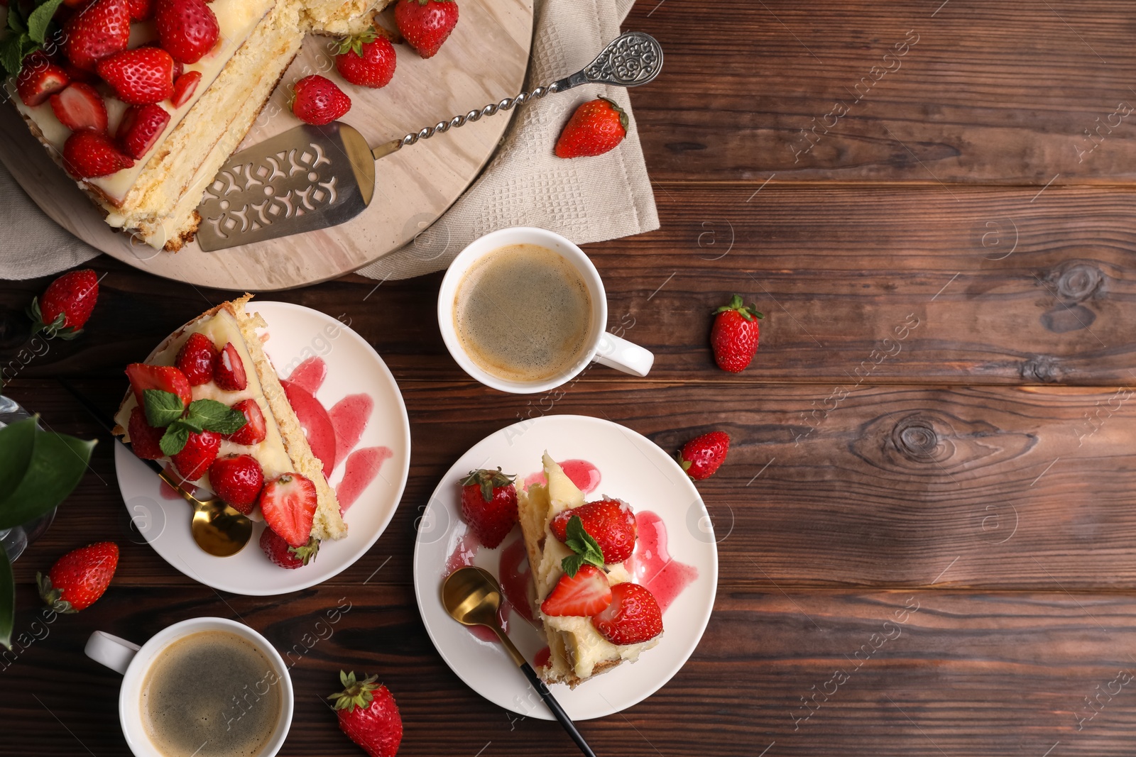 Photo of Tasty cake with fresh strawberries, mint and cups of coffee on wooden table, flat lay. Space for text
