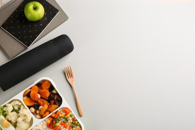 Photo of Flat lay composition with thermos and food on light grey background. Space for text