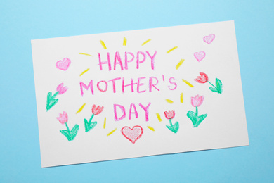 Photo of Handmade greeting card for Mother's day on light blue background, top view
