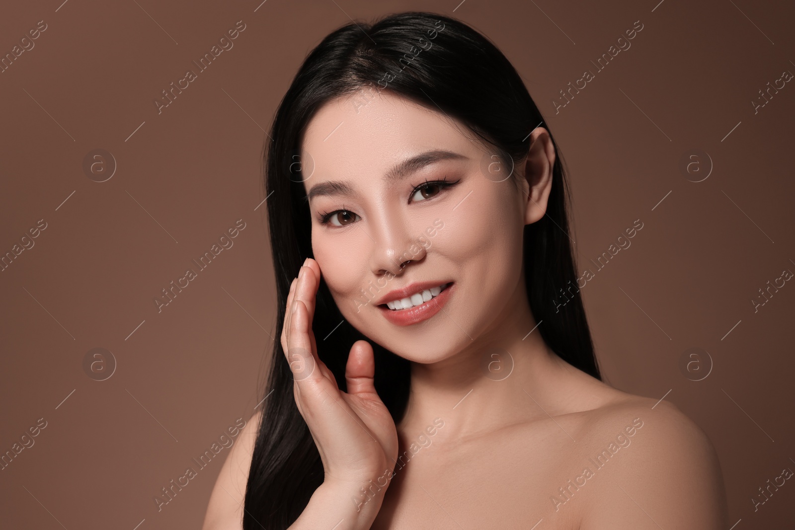 Photo of Portrait of beautiful woman on brown background