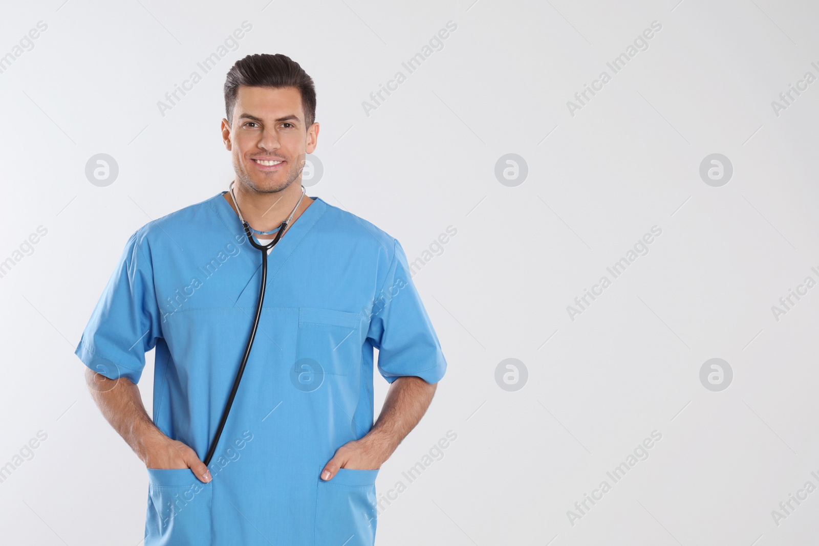 Photo of Doctor with stethoscope on light grey background. Space for text