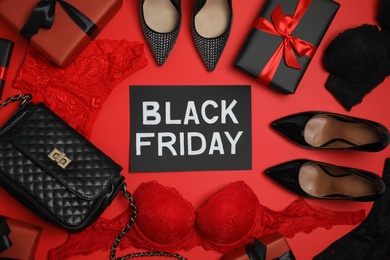 Gift boxes, women's underwear, shoes, accessories and phrase Black Friday on red background, flat lay