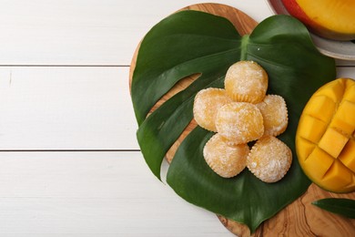 Flat lay composition with delicious mochi and mango on white wooden table, space of text. Traditional Japanese dessert