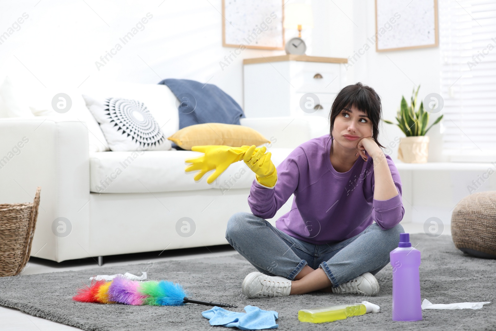 Photo of Lazy woman procrastinating while cleaning at home