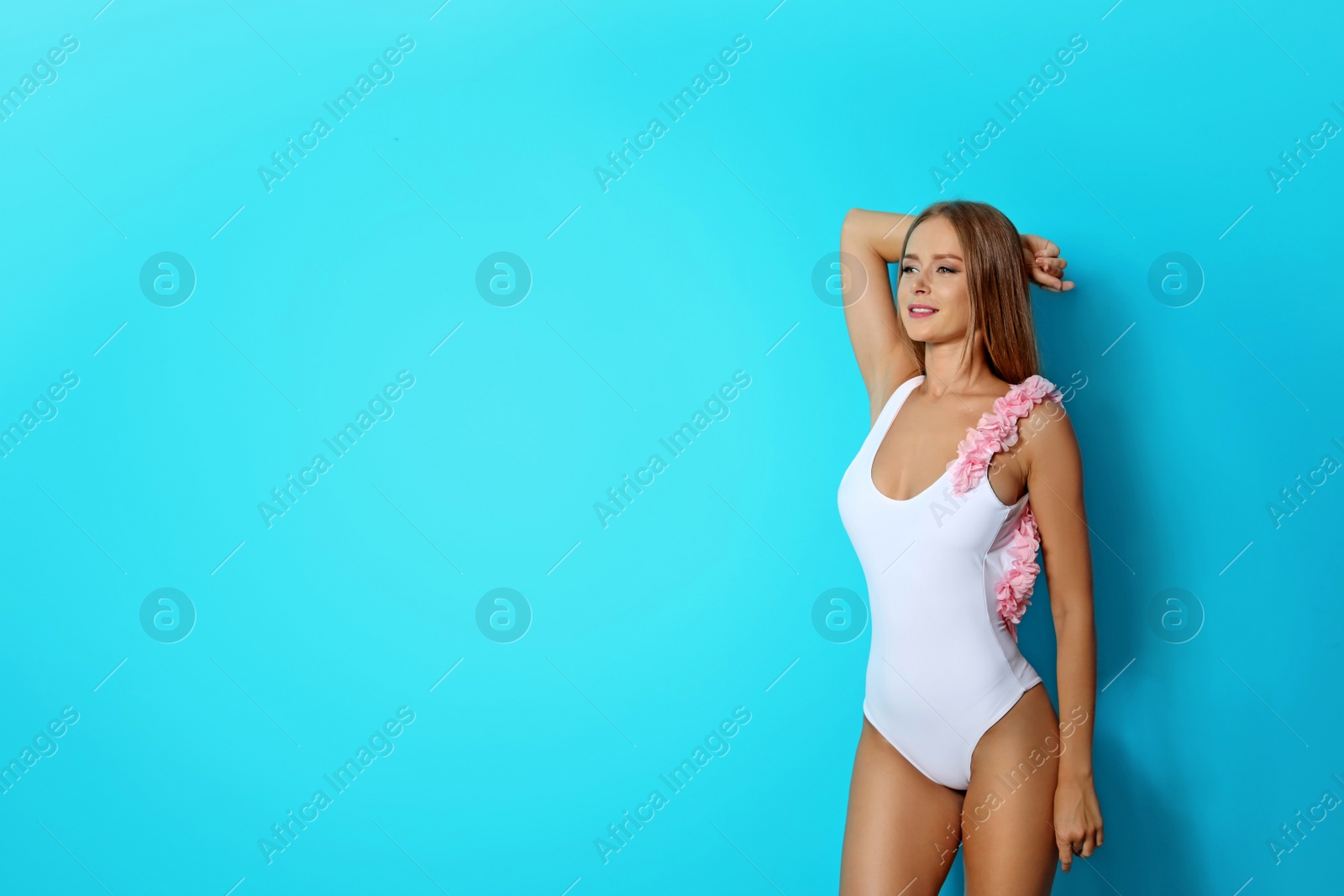 Photo of Sexy young woman in bikini on color background