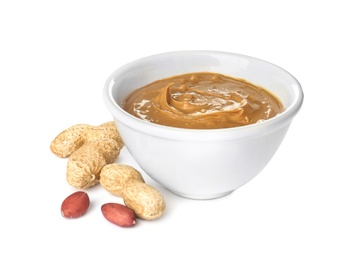 Bowl with creamy peanut butter on white background