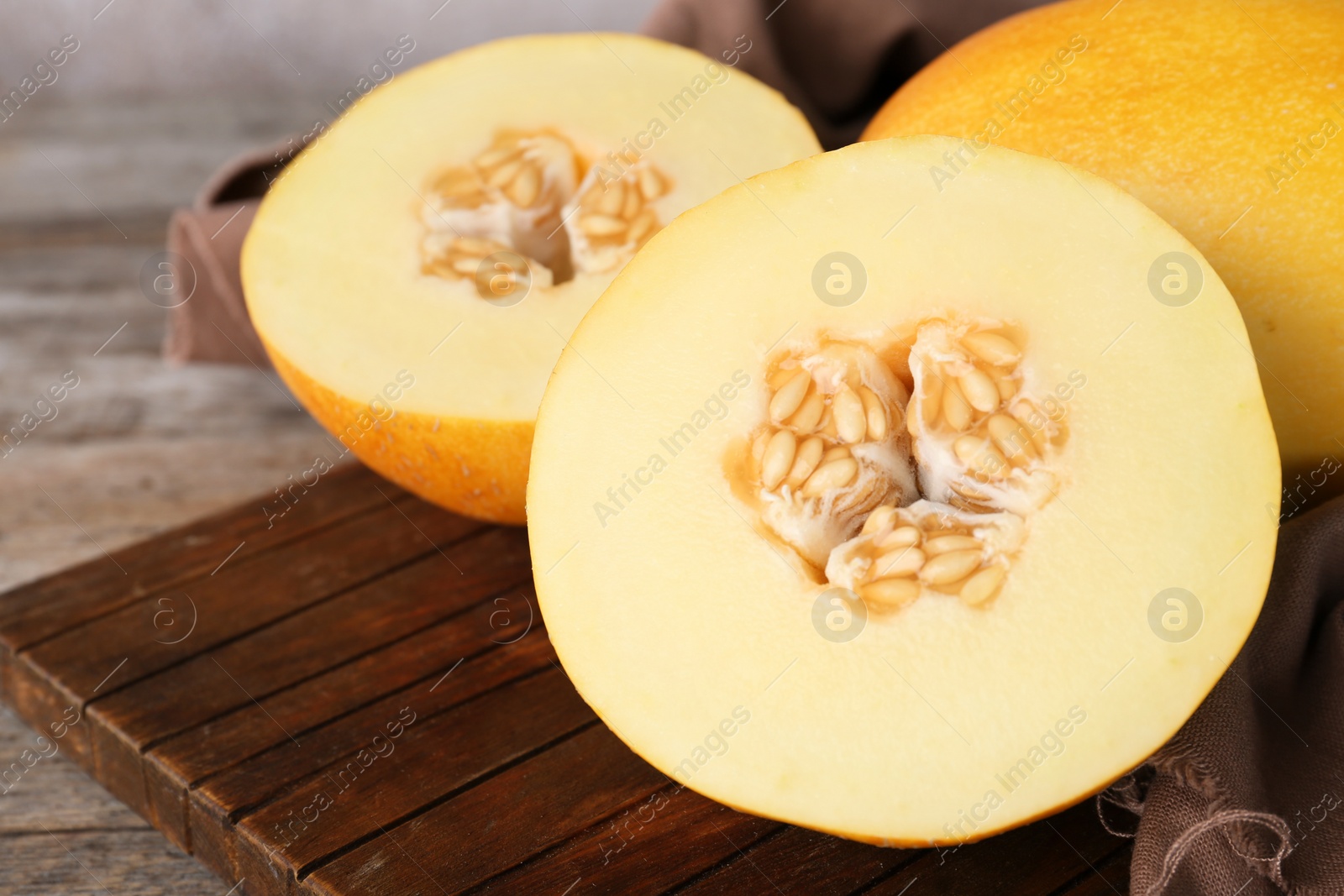 Photo of Sliced ripe sweet melon on wooden table