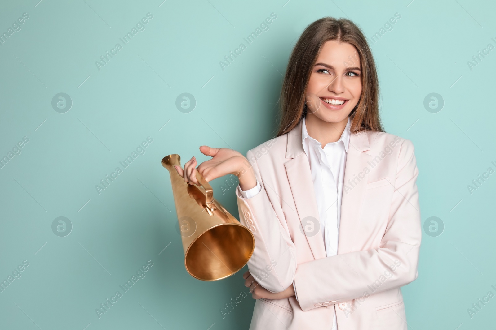 Photo of Young woman with megaphone on color background