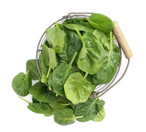 Basket and spinach leaves isolated on white, top view