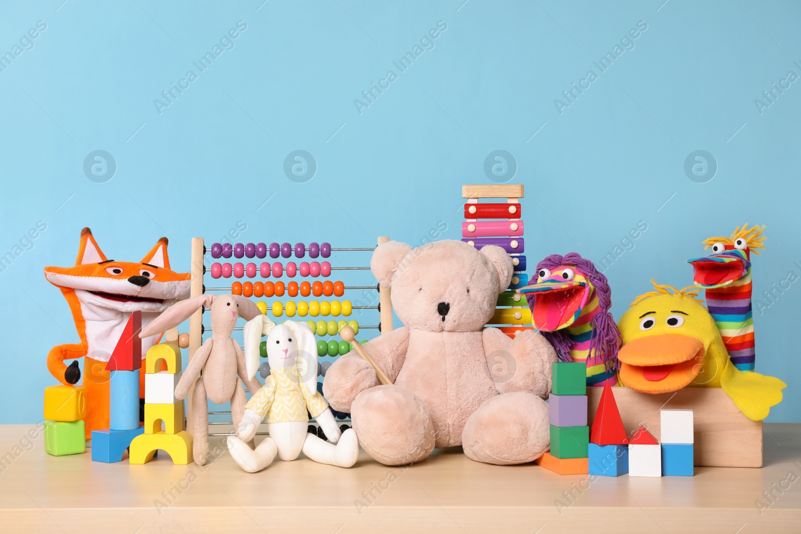 Photo of Collection of different toys on wooden table