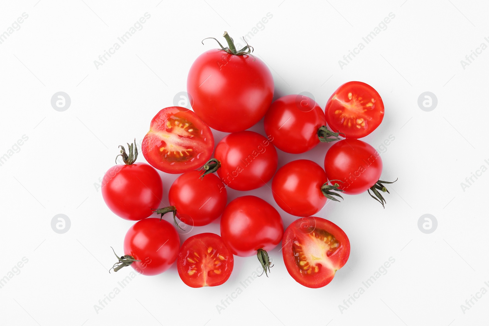 Photo of Whole and cut tomatoes on white background, top view