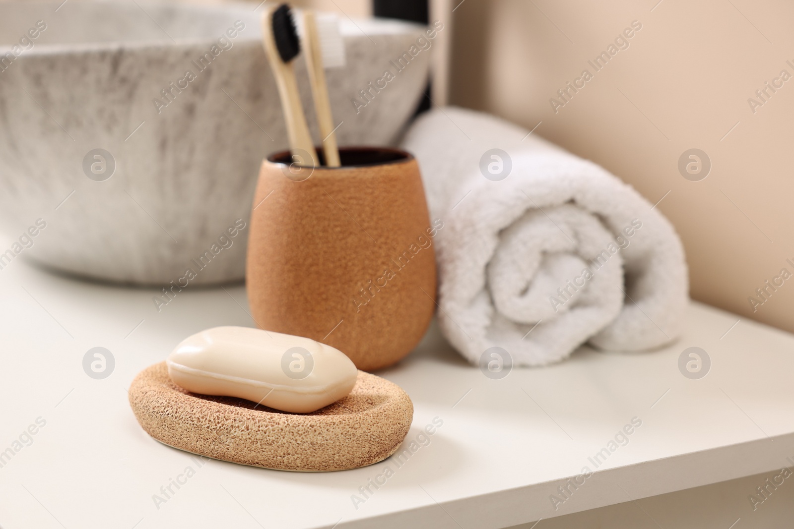 Photo of Different bath accessories and personal care products near sink on bathroom vanity, closeup