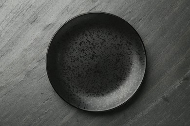 Photo of Beautiful ceramic plate on black table, top view