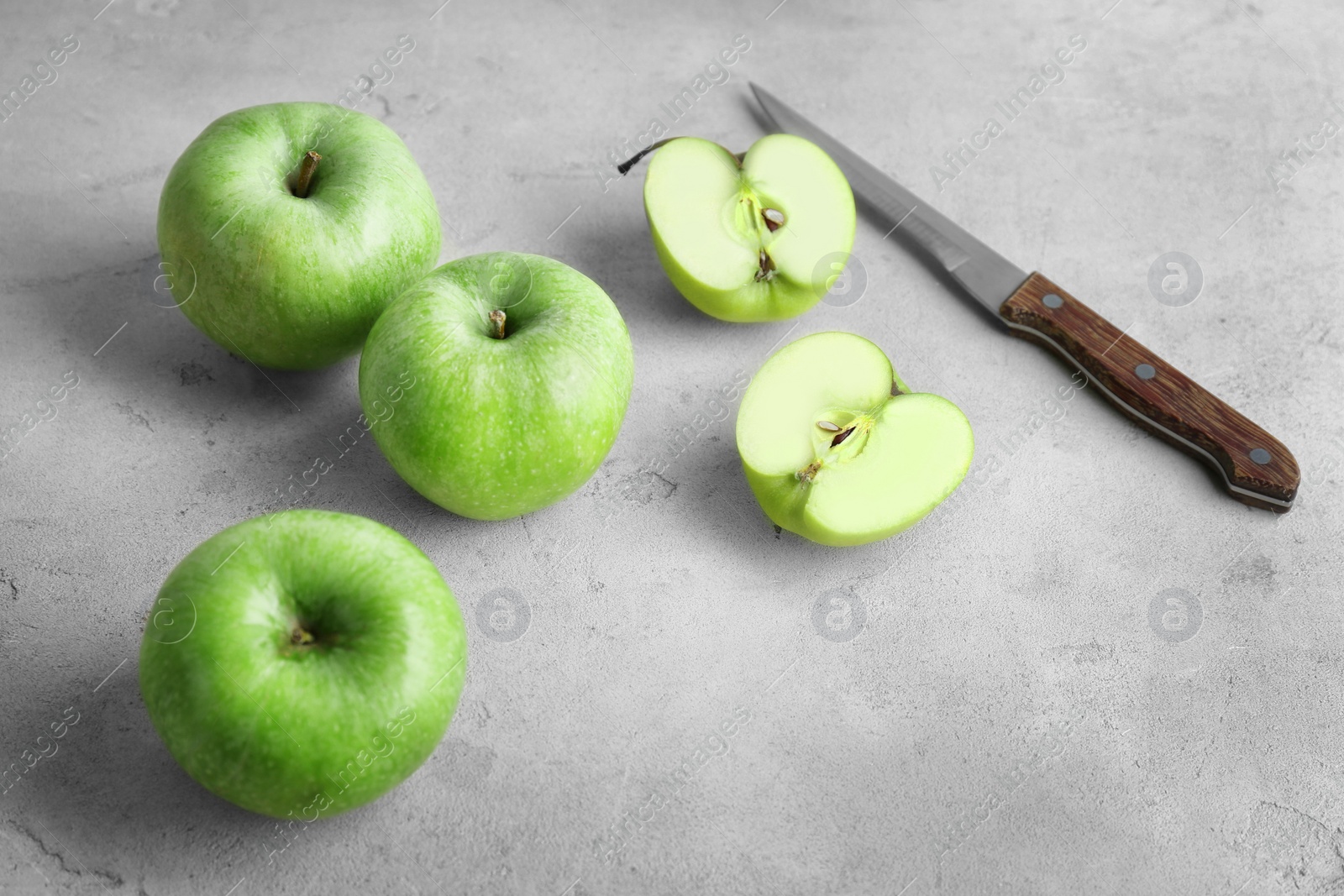 Photo of Fresh green apples and knife on table