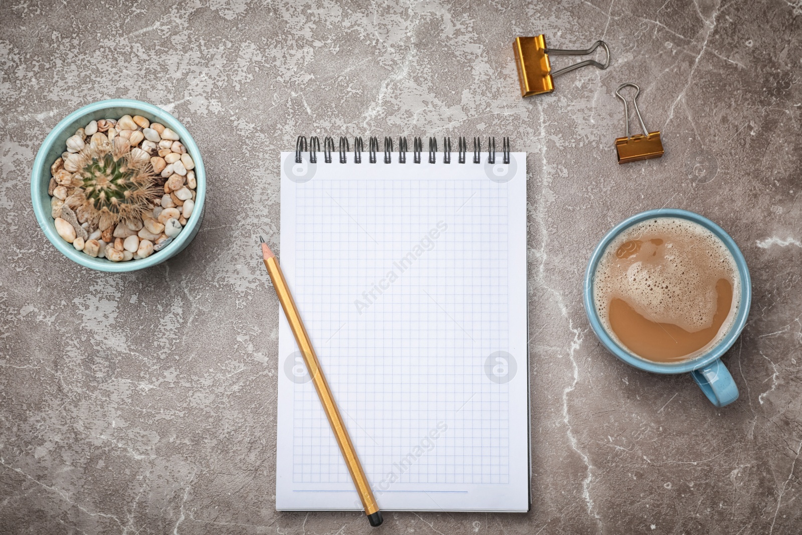 Photo of Flat lay composition with notebook and cup of coffee on grey background