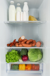 Photo of Open refrigerator full of different fresh products