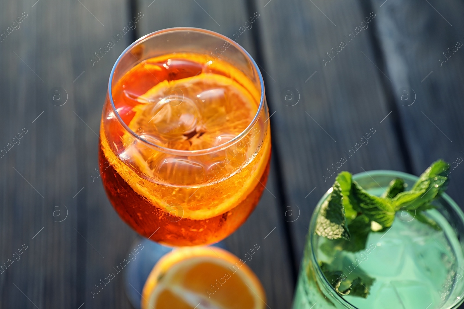 Photo of Glasses of fresh summer cocktails on wooden table, closeup